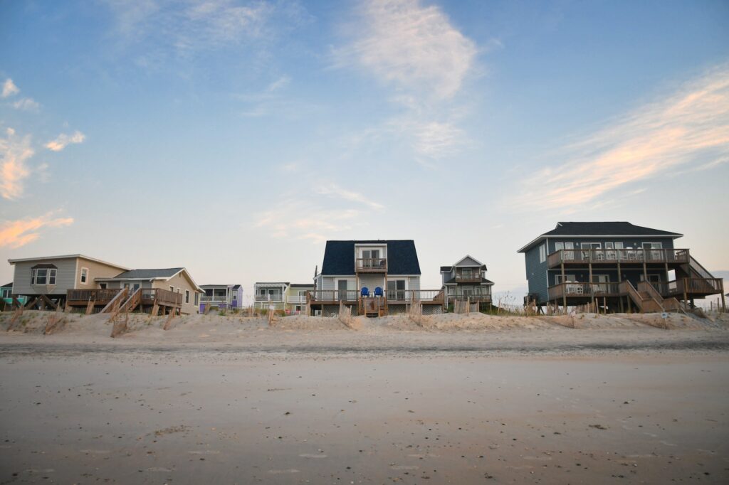 Row of various sized beach cottage vacation homes to rent or buy on the ocean